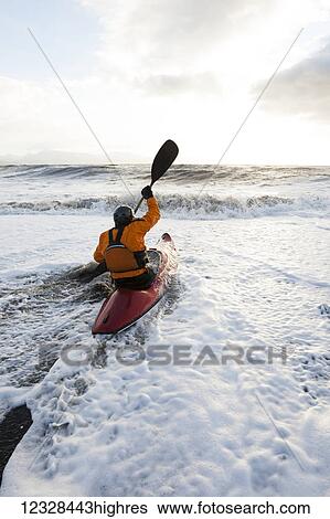 Kayak surfer in his boat entering the ocean, South-central Alaska; Homer, Alaska, United States of America View Large Photo Image Stock Photograph - Kayak surfer in his boat entering the ocean, South-central Alaska; Homer, Alaska, United States of America. Fotosearch