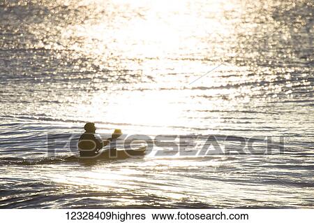 Stock Photograph - Kayaker In Kachemak Bay At Sunset, Southcentral Alaska, USA. Fotosearch