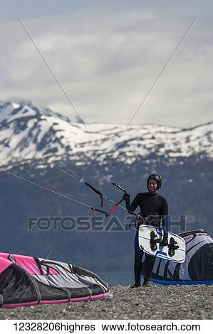Kite Surfer With Board And Holding Kite On The Beach Of Homer, Southcentral Alaska, USA View Large Photo Image Stock Photograph - Kite Surfer With Board And Holding Kite On The Beach Of Homer, Southcentral Alaska, USA. Fotosearch