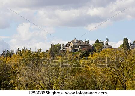 Large homes in a community with a view over a river valley with an autumn coloured forest in the foreground; Edmonton, Alberta, Canada View Large Photo Image Stock Photograph - Large homes in a community with a view over a river valley with an autumn coloured forest in the foreground; Edmonton, Alberta, Canada. Fotosearch