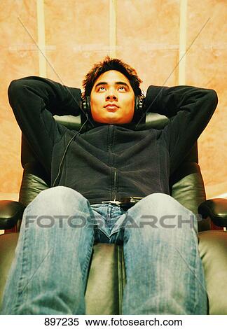 Listening to music on headphones View Large Photo Image Stock Photography - Listening to music on headphones. Fotosearch