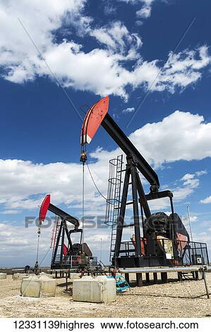 Low Angle View Of Two Pump Jacks With Clouds And Blue Sky; Alberta, Canada View Large Photo Image Stock Photograph - Low Angle View Of Two Pump Jacks With Clouds And Blue Sky; Alberta, Canada. Fotosearch