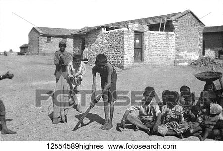 Stock Photograph - Magic lantern slide circa 1880, Victorian/Edwardian Social History. Playing cricket outside the station hospital; Karachi, Pakistan. Fotosearch