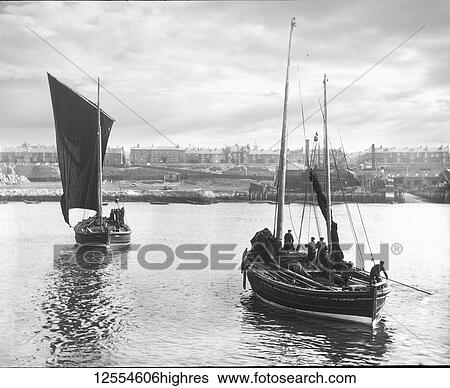 Magic lantern slide circa 1880, Victorian/Edwardian Social History. Two fishing boats leaving harbour with South Shields town in the background. Fishermen can be seen on their sail fishing boats preparing for sea; South Shields, Tyne and Wear, England View Large Photo Image Stock Photograph - Magic lantern slide circa 1880, Victorian/Edwardian Social History. Two fishing boats leaving harbour with South Shields town in the background. Fishermen can be seen on their sail fishing boats preparing for sea; South Shields, Tyne and Wear, England. Fotosearch