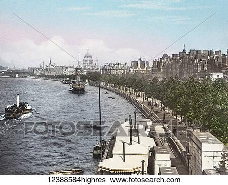 Stock Photograph - Magic Lantern slide circa 1900 hand coloured views of London, England in Victorian times. Looking along the Victoria Embankment towards St Pauls Cathedral. Pleasure paddle steamer on the Thames with sailing ships and small boats.. Fotosearch
