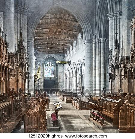 Stock Photograph - Magic Lantern slide circa 1900 hand coloured. created in 1887. A tour of North Wales. 20 Bangor Cathedralinterior. This is an embattled cruciform structure, having a low massive tower, crowned with pinnacles but destitute ot all richness of ornament..... Fotosearch