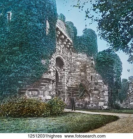 Stock Photograph - Magic Lantern slide circa 1900 hand coloured. created in 1887. A tour of North Wales. 22 Beaumaris Castle is the chief attraction in the town. It is a massive and ponderous structure covering a large extent of ground, but is not so imposing as other.... Fotosearch