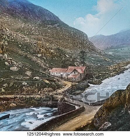 Magic Lantern slide circa 1900 hand coloured. created in 1887. A tour of North Wales. Old Mill and Bridge, Beddgelert. This view is taken from the hill-side on the left of the road leading to Capel Curig, and is a specimen of the pretty scenes so... View Large Photo Image Stock Photograph - Magic Lantern slide circa 1900 hand coloured. created in 1887. A tour of North Wales. Old Mill and Bridge, Beddgelert. This view is taken from the hill-side on the left of the road leading to Capel Curig, and is a specimen of the pretty scenes so.... Fotosearch