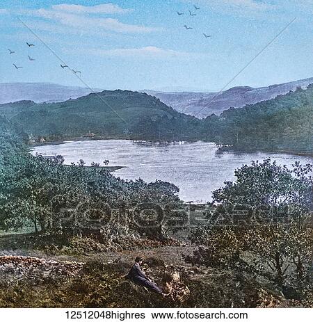 Stock Photograph - Magic Lantern slide circa 1900 hand coloured. created in 1887. A tour of North Wales. 38 Tan-y-BwIch, a view of which place is here shewn. The picturesque little lake has only been formed within recent years, and greatly adds to the beauty of the.... Fotosearch