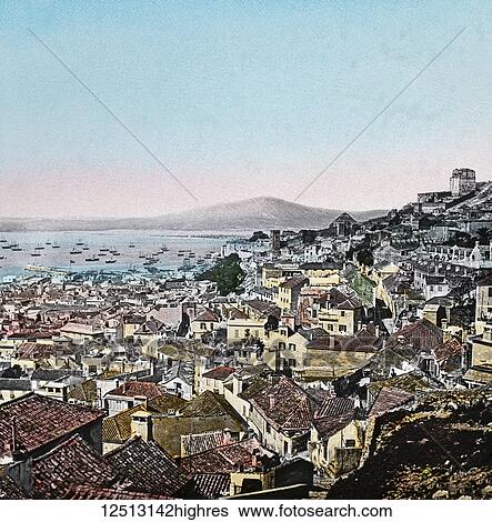Stock Photograph - Magic Lantern slide circa 1900 hand coloured. No. 3. THE TOWN OF GIBRALTAR. The town itself rises on the slopes of the rock, and presents to the eye a curious mixture of Spanish houses, English villas, and, in some cases, Moorish buildings. The streets.... Fotosearch