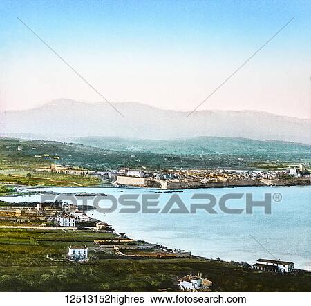 Stock Photograph - Magic Lantern slide circa 1900 hand coloured. Titled Cities and places of interest in the Mediterranean. 14- ANTIBES. This shows us a view of one of the most charming spots in the whole of the delightful neighbourhood of the Riviera. There is no place.... Fotosearch