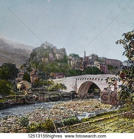 Stock Photograph - Magic Lantern slide circa 1900 hand coloured. Titled Cities and places of interest in the Mediterranean. 17- CORSICA. Looking down from Nice across the sparkling waters to the south, in the early morning, the eye rests on a dim haze that presently.... Fotosearch