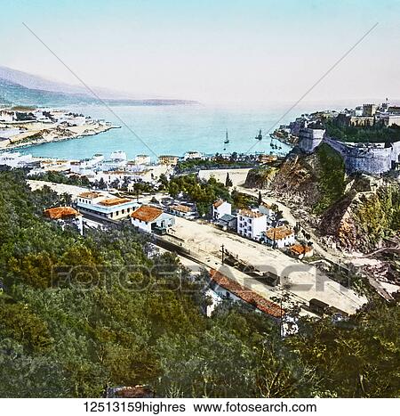 Stock Photograph - Magic Lantern slide circa 1900 hand coloured. Titled Cities and places of interest in the Mediterranean. 23. MONACO AND MONTE CARLO. Very few people ever visit Nice, or any town in the locality, without also going to see Monte Carloa portion of the.... Fotosearch