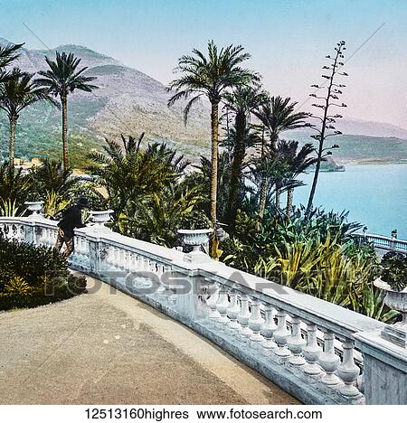 Stock Photograph - Magic Lantern slide circa 1900 hand coloured. Titled Cities and places of interest in the Mediterranean. 24-MONTE CARLO GARDENS. These gardens, as indeed the whole of the place, might lead the visitor to believe he was in fairyland, so beautiful are.... Fotosearch
