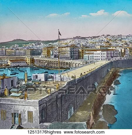 Stock Photograph - Magic Lantern slide circa 1900 hand coloured. Titled Cities and places of interest in the Mediterranean. 44ALGIERS PROM THE HARBOUR. We go still farther south, indeed to the remote ends of the Mediterranean, and we arrive on the, northern shores of.... Fotosearch