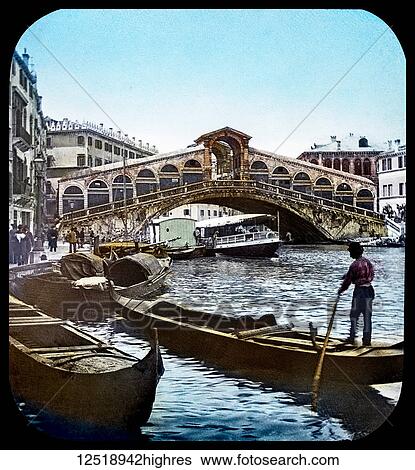 Stock Photograph - Magic Lantern slide circa 1900 hand coloured. Victorian/Edwardian era. The Rialto Bridge (Italian: Ponte di Rialto; Venetian: Ponte de Rialto) is the oldest of the four bridges spanning the Grand Canal in Venice, Italy. Connecting the sestieri.... Fotosearch
