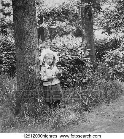 Stock Photograph - Magic lantern slide circa 1900. Victorian. A little girl playing in the woods in Farringdon. Fotosearch