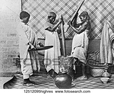 Stock Photograph - Magic lantern slide circa 1900. Victorian. Social History. Hova Women pounding rice Madagascar. Slide from S. P. G., the society for the propogation of the gospels to foreign parts. The rice is then taken to the neighbouring village or homestead and is.... Fotosearch