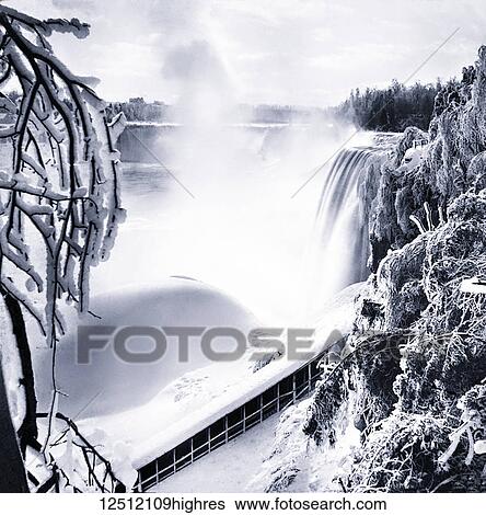 Stock Photograph - Magic lantern slide circa 1900. Victorian. Social History. Frozen Niagra Falls with heavy snow and ice. Fotosearch