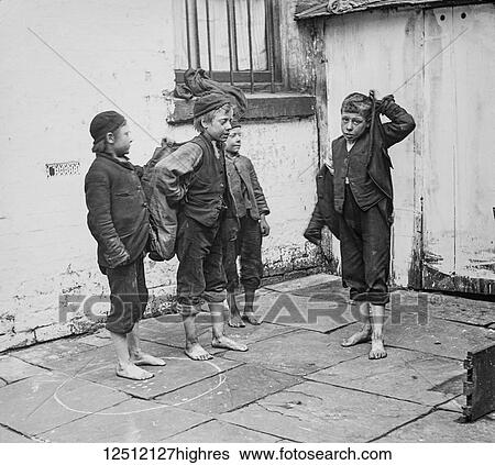 Stock Photograph - Magic lantern slide circa 1900. Victorian. Social History. Street children in Victorian times were found in abundance living in alleys or side streets. Many were orphans but a large part of the street children were from neglectful, alcoholic families.... Fotosearch