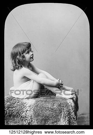 Stock Photograph - Magic lantern slide circa 1900. Victorian. A little girl poses in the studio for a photograph. Fotosearch