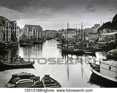 Stock Photograph - Magic lantern slide circa 1900. Victorian. Alesund Harbour. lesund (Norwegian pronunciation: [??l? s? n] (About this sound listen)) is a town and municipality in Mre og Romsdal county, Norway. It is part of the traditional district of Sunnmre, and the.... Fotosearch