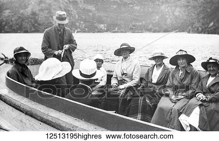 Stock Photograph - Magic lantern slide circa 1900. Victorian/Edwardian social history. Family fun boating trip on lake Wakatipu, an inland lake (finger lake) in the South Island of New Zealand. It is in the southwest corner of the Otago region, near its boundary with.... Fotosearch