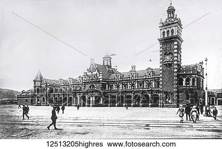Stock Photograph - Magic lantern slide circa 1900. Victorian/Edwardian social history. Dunedin Railway Station in Dunedin on New Zealand's South Island, designed by George Troup, is the city's fourth station. It earned its architect the nickname of Gingerbread George. In.... Fotosearch