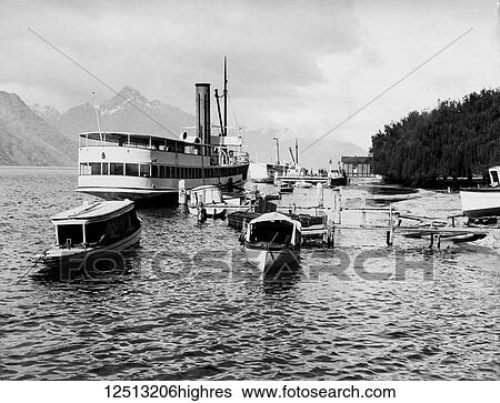 Stock Photograph - Magic lantern slide circa 1900. Victorian/Edwardian social history. The TSS Earnslaw is a 1912 Edwardian vintage twin screw steamer plying the waters of Lake Wakatipu in New Zealand. It is one of the oldest tourist attractions in Central Otago, and the.... Fotosearch