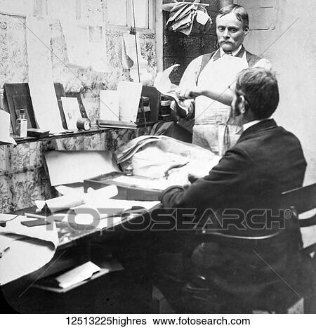 Magic lantern slide circa 1900. Victorian. Social History. Image from a slide presentation entitled In His step or In jesus Name. Printer in office discussing advertising with managing director. View Large Photo Image Stock Photograph - Magic lantern slide circa 1900. Victorian. Social History. Image from a slide presentation entitled In His step or In jesus Name. Printer in office discussing advertising with managing director.. Fotosearch