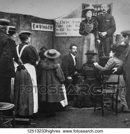 Stock Photograph - Magic lantern slide circa 1900. Victorian. Social History. Image from a slide presentation entitled In His step or In jesus Name. A lady preaching in church to a small congregation. Signs and messages about christ saving sinners. Fotosearch