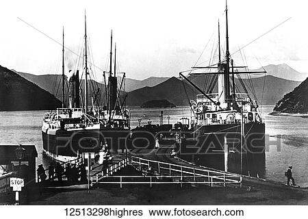 Stock Photograph - Magic lantern slide circa 1900. Victorian/Edwardian social history, Thw warf, Picton New Zealand with ships tied to the pier.. Fotosearch