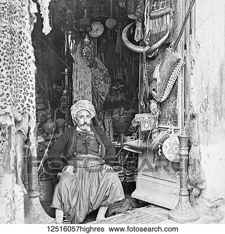 Magic lantern slide circa 1900. Victorian/Edwardian. Social History. No. I6The Bazaar. The Bazaar is an institution of Eastern life. It is a place where much time and money may he spent in purchasing Oriental wares. This picture gives us a good idea of a... View Large Photo Image Stock Photograph - Magic lantern slide circa 1900. Victorian/Edwardian. Social History. No. I6The Bazaar. The Bazaar is an institution of Eastern life. It is a place where much time and money may he spent in purchasing Oriental wares. This picture gives us a good idea of a.... Fotosearch