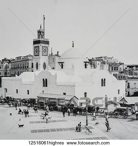 Stock Photograph - Magic lantern slide circa 1900. Victorian/Edwardian. Social History. No. 3. Mosque and Place du Governement. Were it not for the Mosque, which forms such a prominent feature in the view before us, we might almost imagine this square to belong to any.... Fotosearch