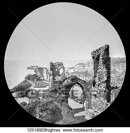 Stock Photograph - Magic lantern slide circa 1900. Victorian/Edwardian. Social History. Hastings Castle is a keep and bailey castle ruin situated in the town of Hastings, East Sussex.. Fotosearch