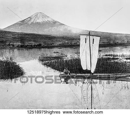 Stock Photograph - Magic lantern slide circa 1900. Victorian/Edwardian. Social History. Japanese fisherman in boat in front of mount Fuji, Fujiama located on Honshu Island, is the highest mountain in Japan.. Fotosearch
