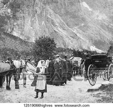 Stock Photograph - Magic lantern slide circa 1900. Victorian/Edwardian. Social History. picture of travelling people through mountains with horses and coaches, Possibly refugees fleeing war.. Fotosearch