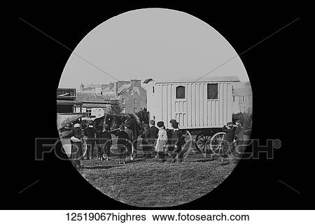 Stock Photograph - Magic lantern slide circa 1900. Victorian/Edwardian. Social History. A travelkling fair or circus with caravan and children. Fotosearch