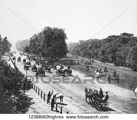 Stock Photograph - Magic Lantern slide circa 1900 views of London, England in Victorian times. Rotten Row Hyde Park. Horses, carraiges and people walking in the park. Fotosearch
