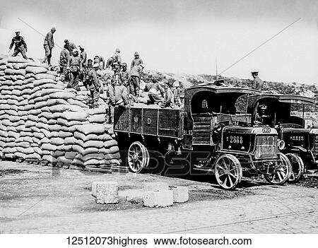 Stock Photograph - Magic Lantern Slide depicting men of the Chinese Labour Corps stacking sacks of corn at Boulogne during World War 1; Boulogne, France. Fotosearch