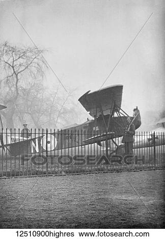 Stock Photograph - Magic lantern slide WW1, 1914-1918, World war one images. British aircraft with soldier on guard. Display of captured German weapons and artillary at Horse Guards Parade, London 3rd November 1915.. Fotosearch