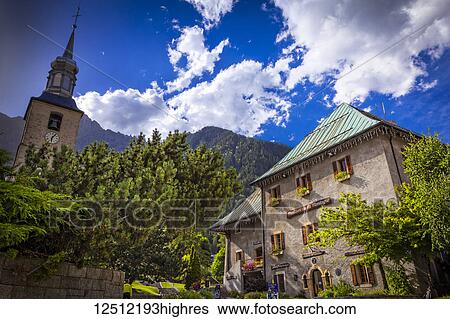 Stock Photograph - Maison de la Montagne and St Michel Church at Chamonix City Center; Chamonix-Mont-Blanc, Haute-Savoie, France. Fotosearch