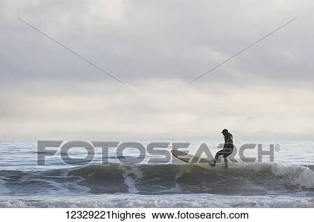 Man catching a wave while surfing, Southeast Alaska; Yakutat, Alaska, United States of America View Large Photo Image Stock Photograph - Man catching a wave while surfing, Southeast Alaska; Yakutat, Alaska, United States of America. Fotosearch