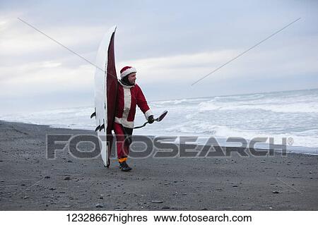 Man dressed in a santa suit with kayak along the coast of Homer, Kenai Peninsula, South-central Alaska; Homer, Alaska, United States of America View Large Photo Image Stock Photograph - Man dressed in a santa suit with kayak along the coast of Homer, Kenai Peninsula, South-central Alaska; Homer, Alaska, United States of America. Fotosearch