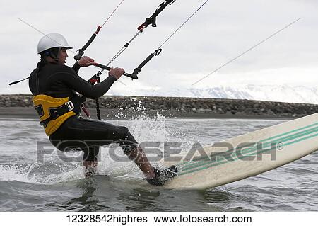 Man kitesurfing in Kachemak Bay, South-central Alaska; Alaska, United States of America View Large Photo Image Stock Photograph - Man kitesurfing in Kachemak Bay, South-central Alaska; Alaska, United States of America. Fotosearch