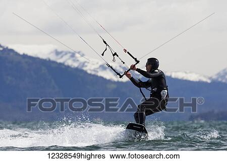 Stock Photograph - Man kitesurfing in Kachemak Bay, South-central Alaska; Alaska, United States of America. Fotosearch