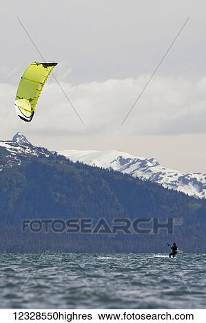 Stock Photograph - Man kitesurfing in Kachemak Bay, South-central Alaska; Alaska, United States of America. Fotosearch