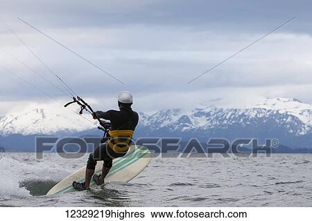 Man kitesurfing in Kachemak Bay, South-central Alaska; Alaska, United States of America View Large Photo Image Stock Photograph - Man kitesurfing in Kachemak Bay, South-central Alaska; Alaska, United States of America. Fotosearch