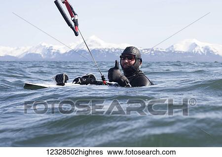 Man kitesurfing with Kenai Mountains in the background, Homer, South-central Alaska; Homer, Alaska, United States of America View Large Photo Image Stock Photograph - Man kitesurfing with Kenai Mountains in the background, Homer, South-central Alaska; Homer, Alaska, United States of America. Fotosearch