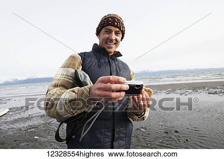 Man on a Homer beach with a digital camera, South-central Alaska; Alaska, United States of America View Large Photo Image Stock Photograph - Man on a Homer beach with a digital camera, South-central Alaska; Alaska, United States of America. Fotosearch